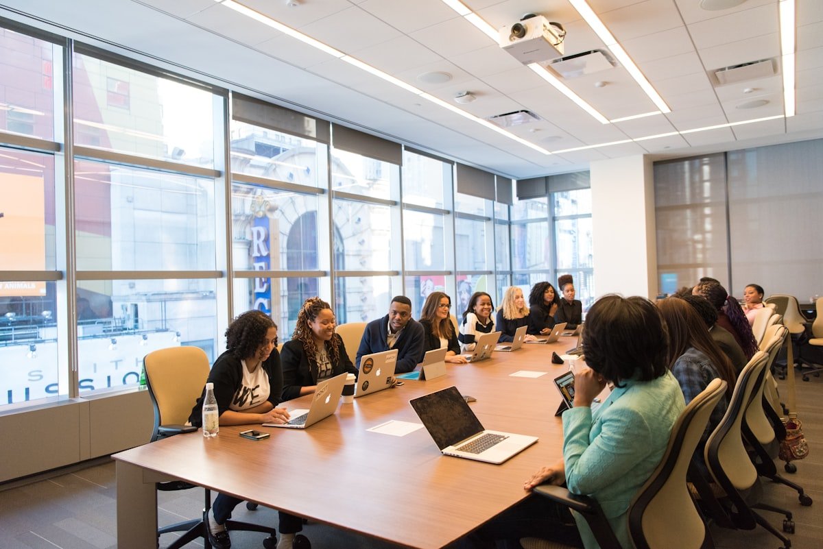 Small business team working together at a table with laptops