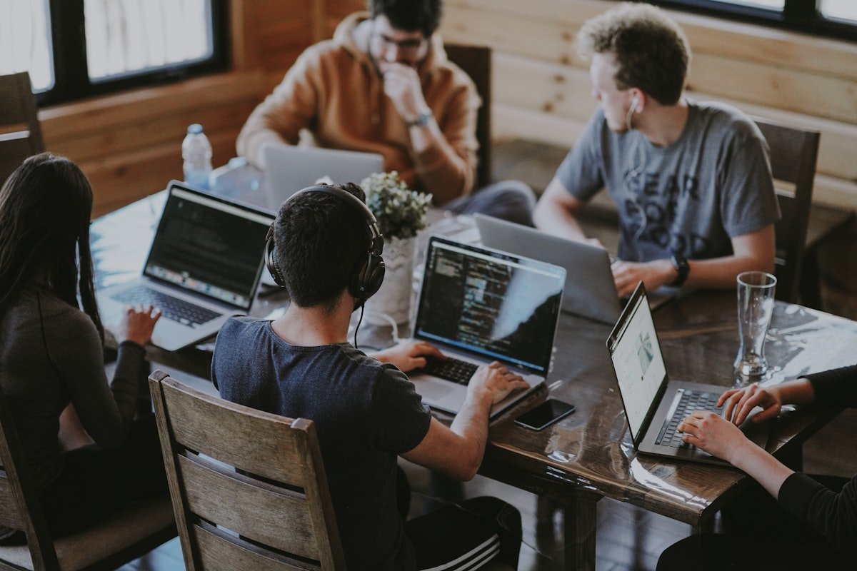 Group of young founders collaborating on a laptop, representing a startup team